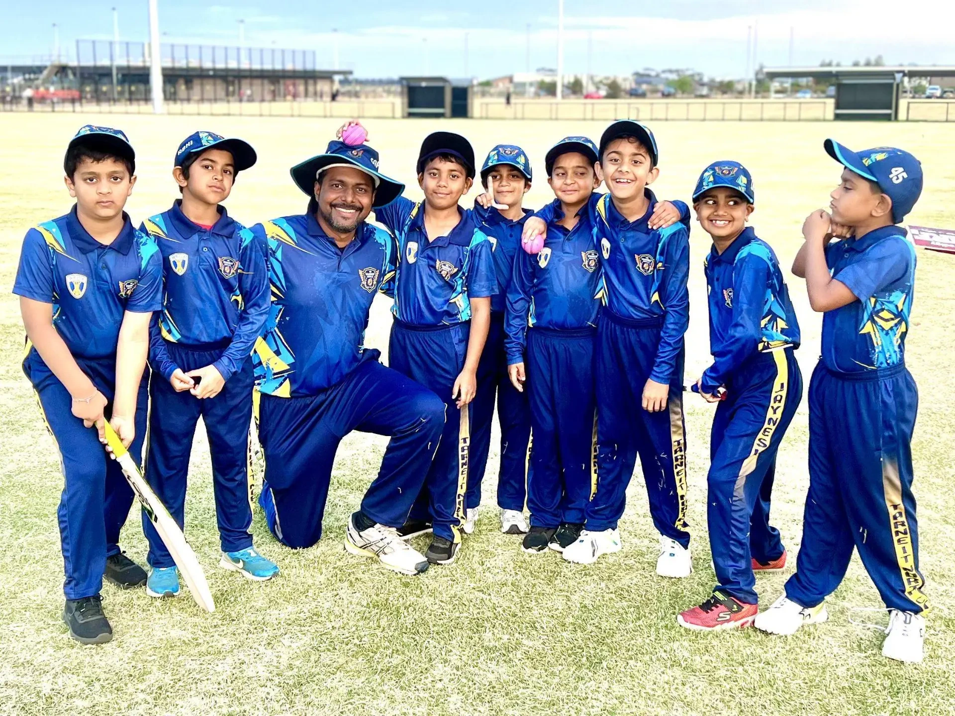 TNCC junior team photo with their coach after a match