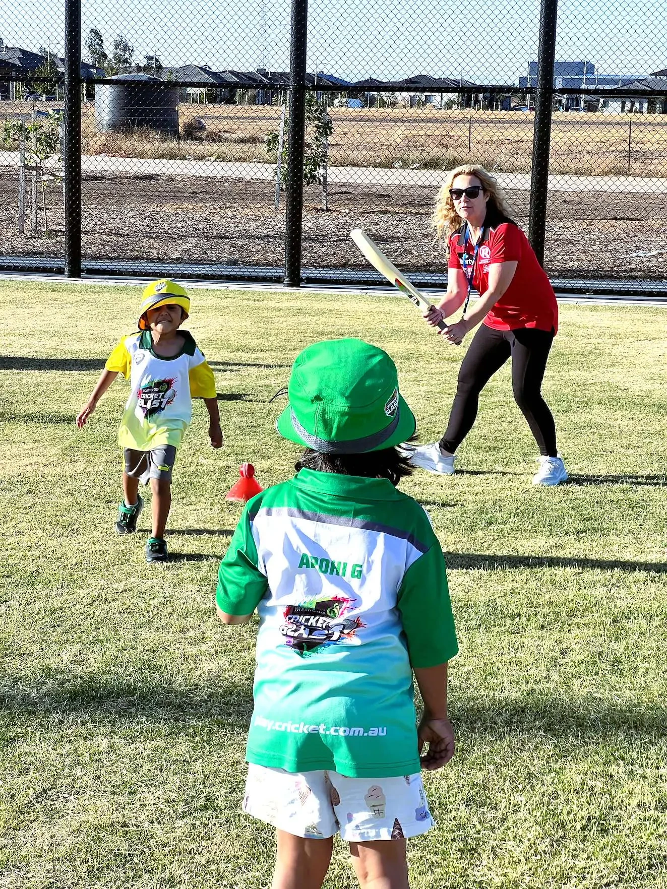 Young Cricket Blast players batting off a tee